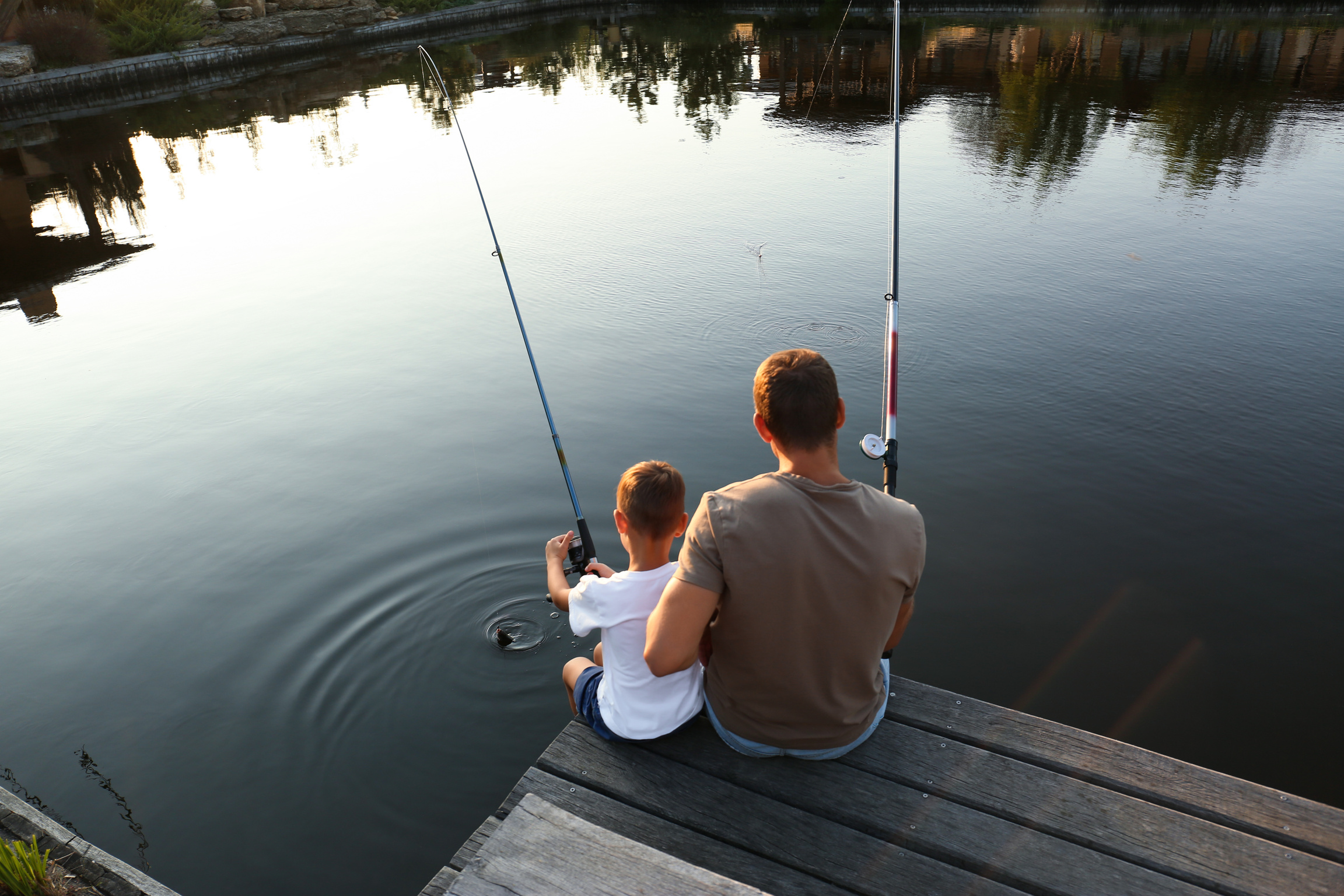 Dad and Son Fishing Together on Sunny Day